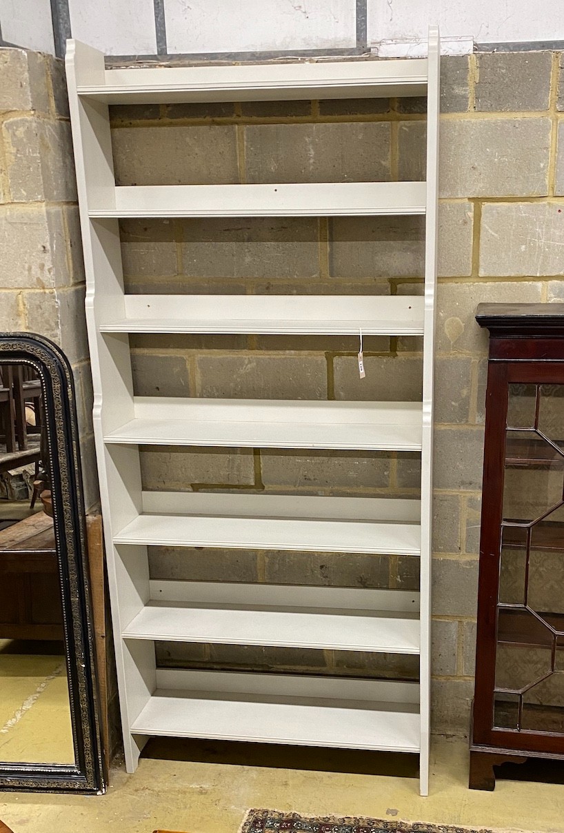 A modern painted open bookcase, width 100cm, depth 28cm, height 224cm